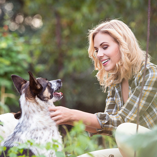 Happy dog and owner in fenced yard